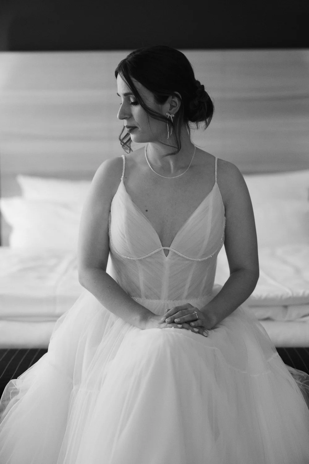 Bride in tulle wedding dress sitting calmly before the ceremony