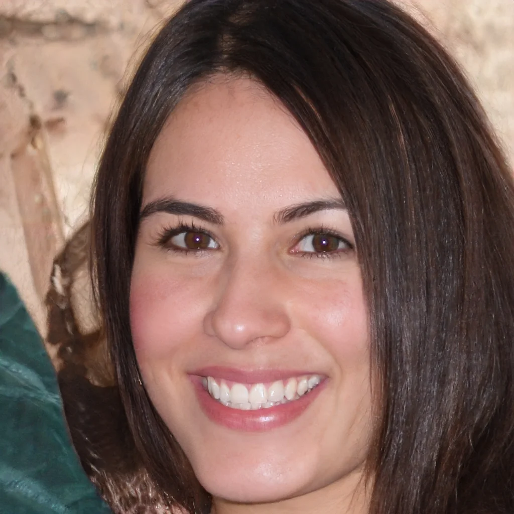 Close-up of a smiling woman with brown hair and brown eyes