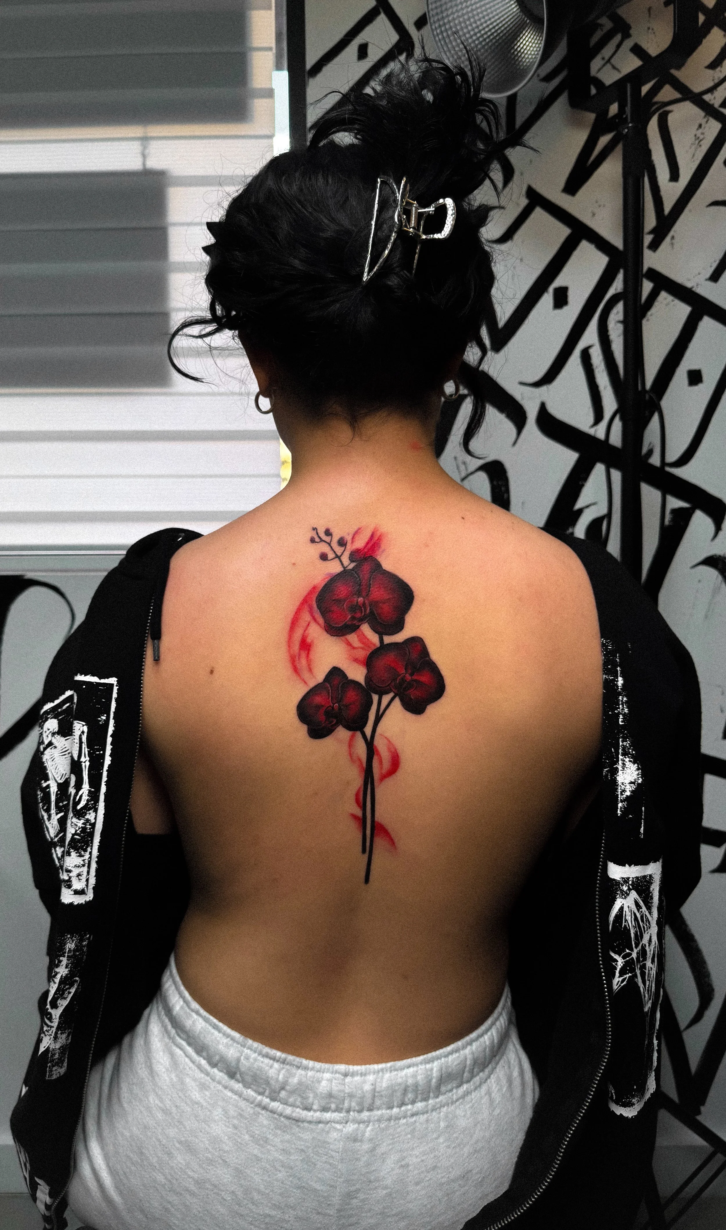 Back Tattoo of a realistic red orchid by Jensen R The inkmobster at Fiallo tattoo walk-in studio in Miami