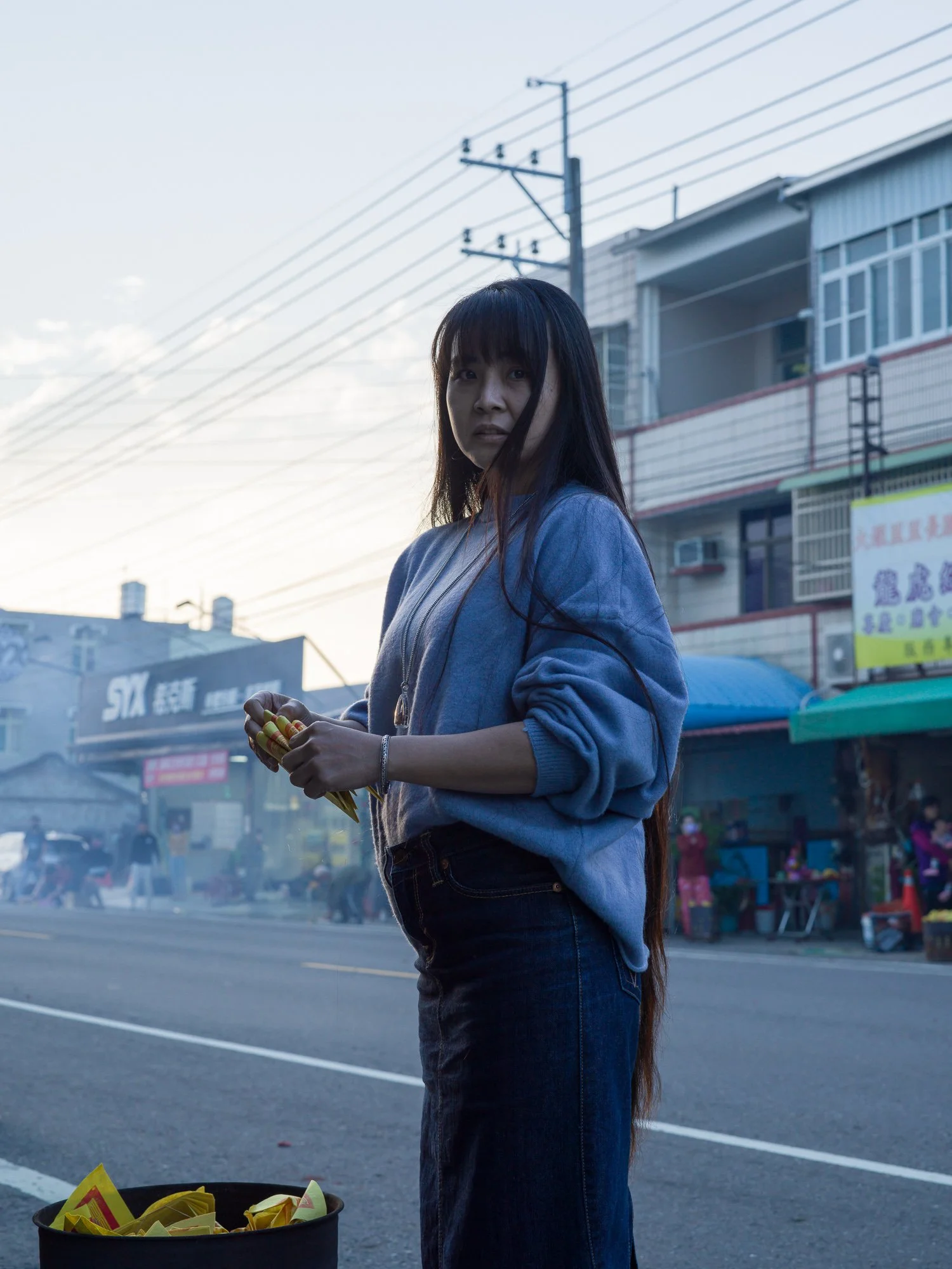 "Nana holding joss paper for a traditional ritual.

Ka-lí, Tainan, Taiwan 2022."