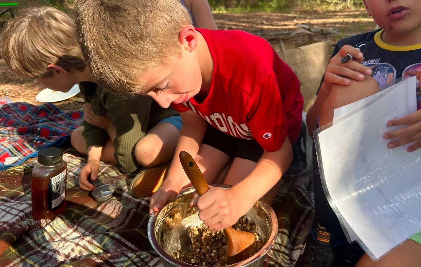 Cooking up something sweet! Our group followed a recipe together, measuring oats and honey and taking turns stirring the bowl. Cooking outdoors gives kids so many chances to practice what we work on: following steps in order, using both hands togethe