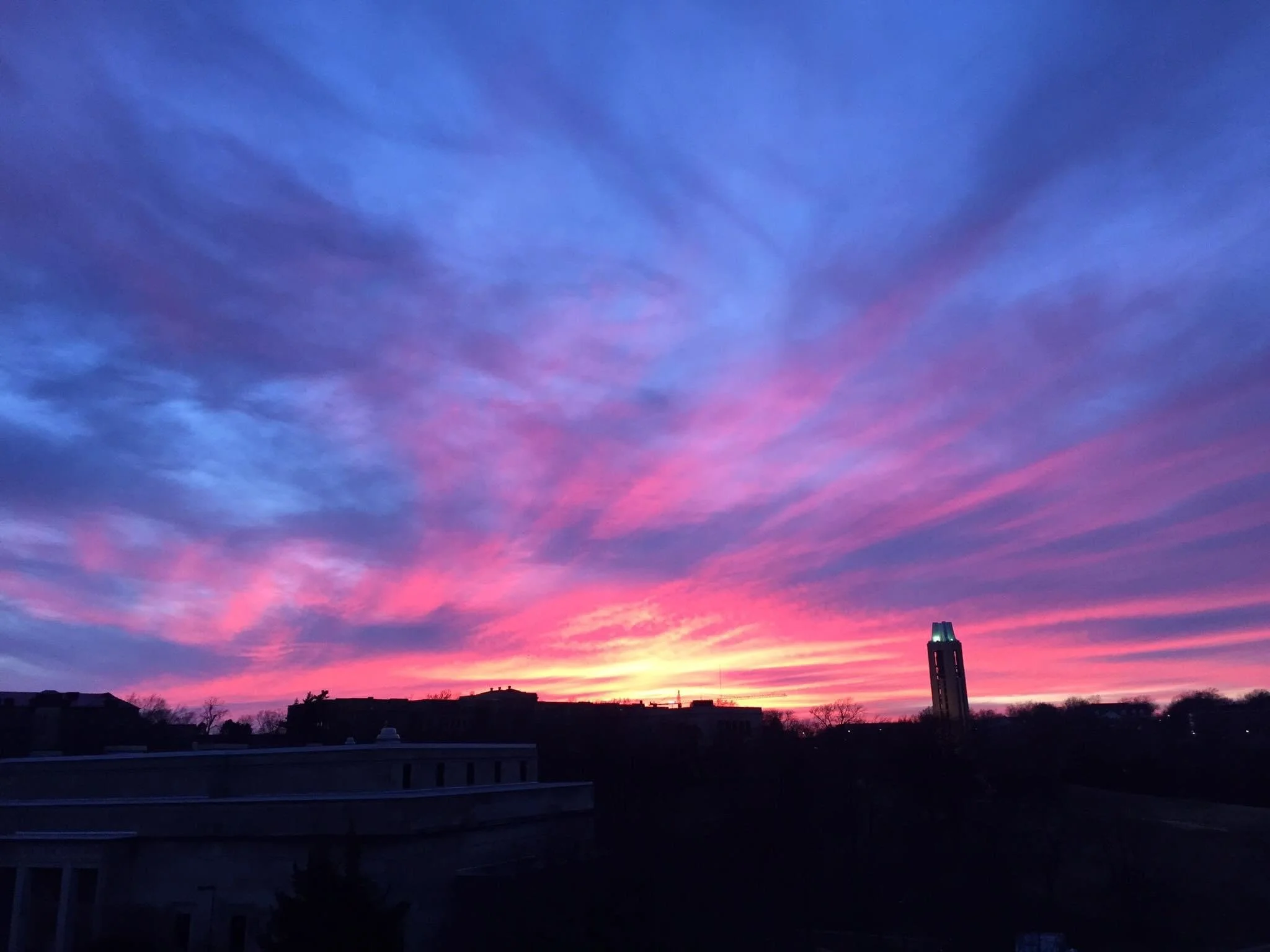 About Us - photo of a sunset over the University of Kansas campus