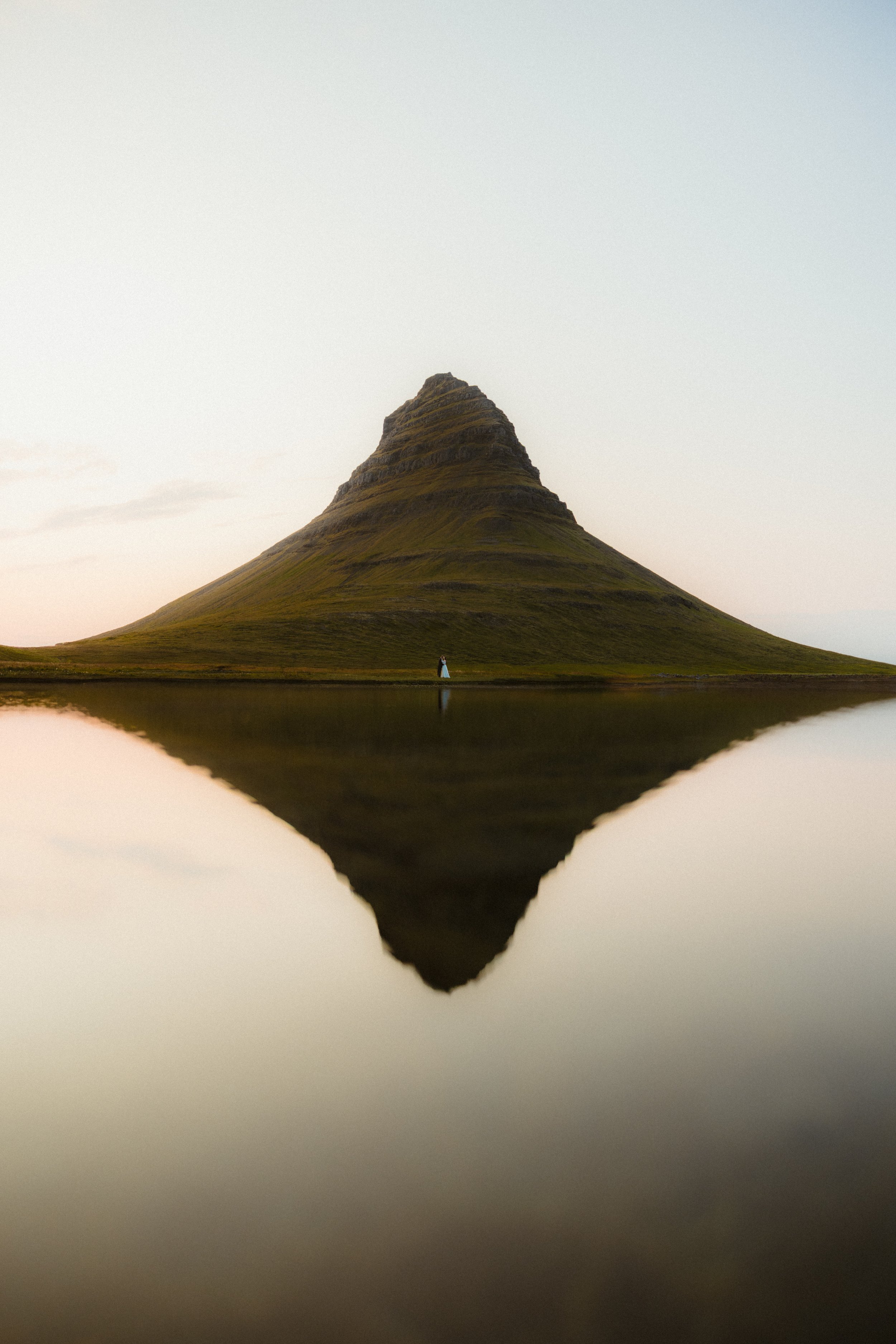 bride and groom stand in front of mountain during iceland elopement