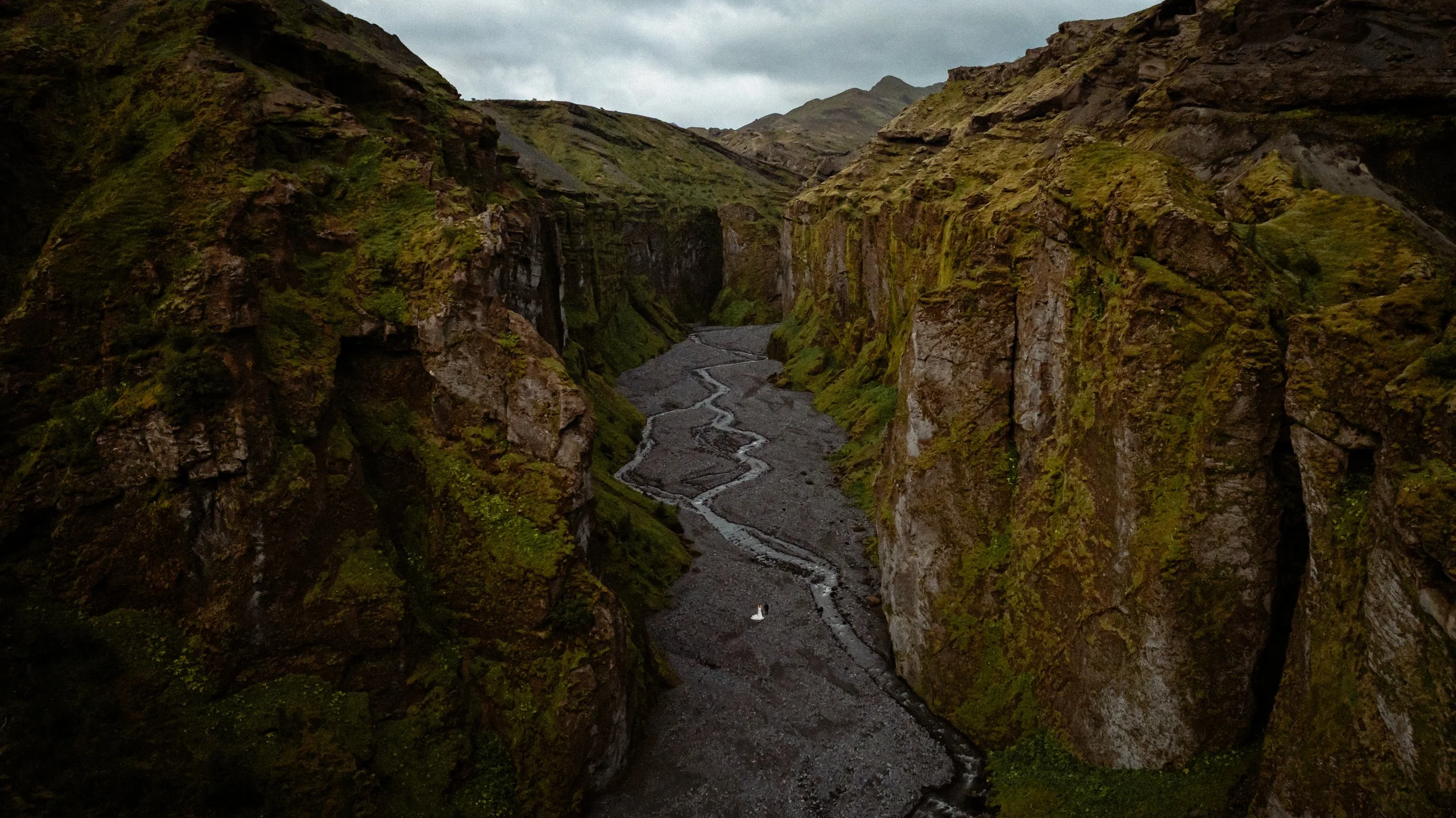 bride and groom stand in valley during iceland elopement photos