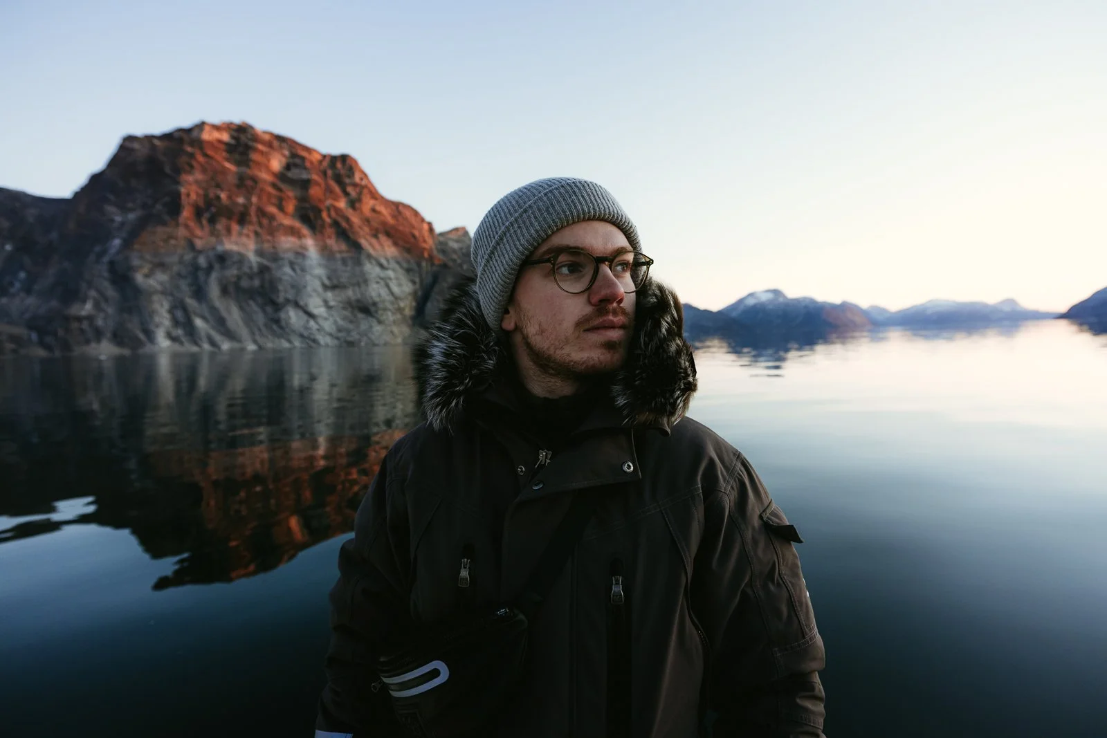 iceland elopement photographer looks out at the landscape from a boat