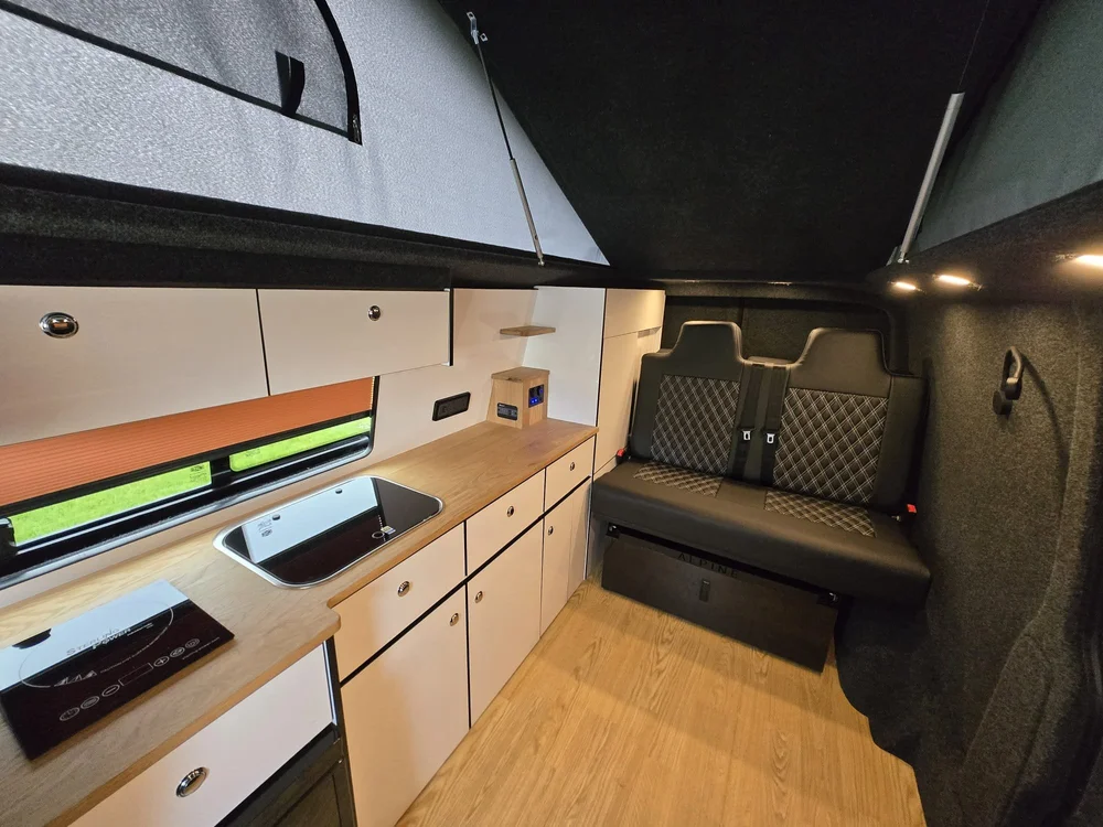 Family-friendly layout inside a VW T6.1 camper conversion designed for comfortable travel and storage