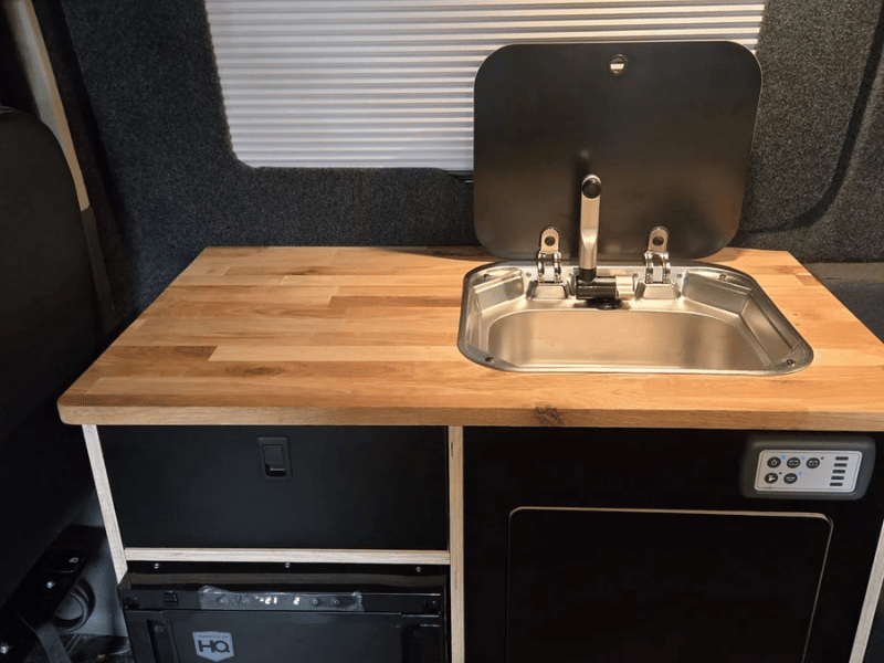 Kitchen unit inside Ford Transit Custom camper conversion with sink and storage