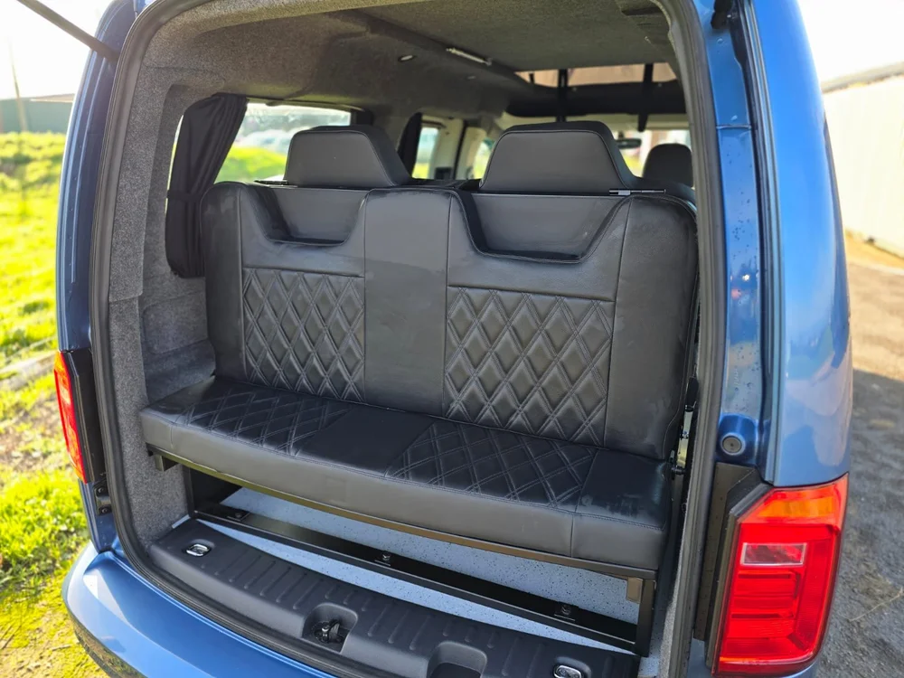 Rear seating area inside custom VW Caddy campervan conversion