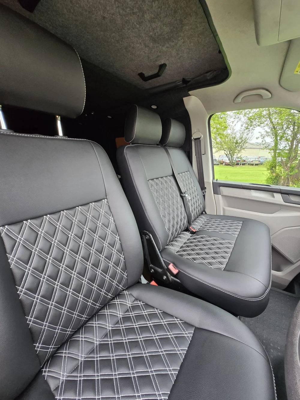 Front cab seats with swivel base in a VW T6.1 camper conversion creating additional living space