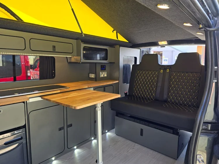 Custom Vivaro campervan interior with bespoke kitchen, seating and storage