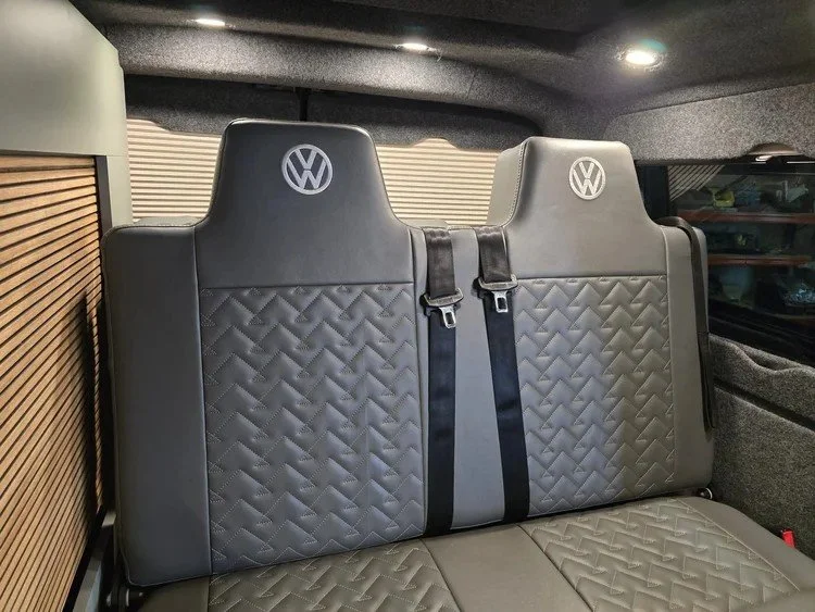 Bespoke campervan upholstery with custom-finished seats, cushions and interior trim.