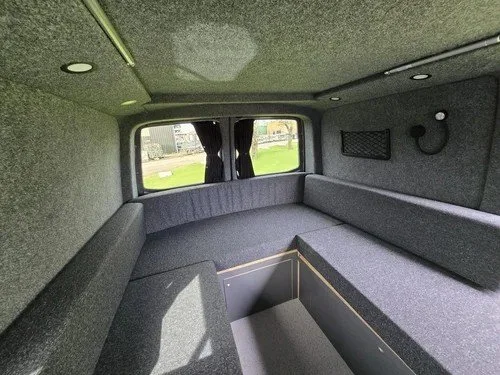 U-shaped lounge layout inside bespoke VW campervan conversion