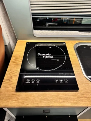 Induction hob installed in bespoke VW T6.1 campervan conversion for off-grid cooking