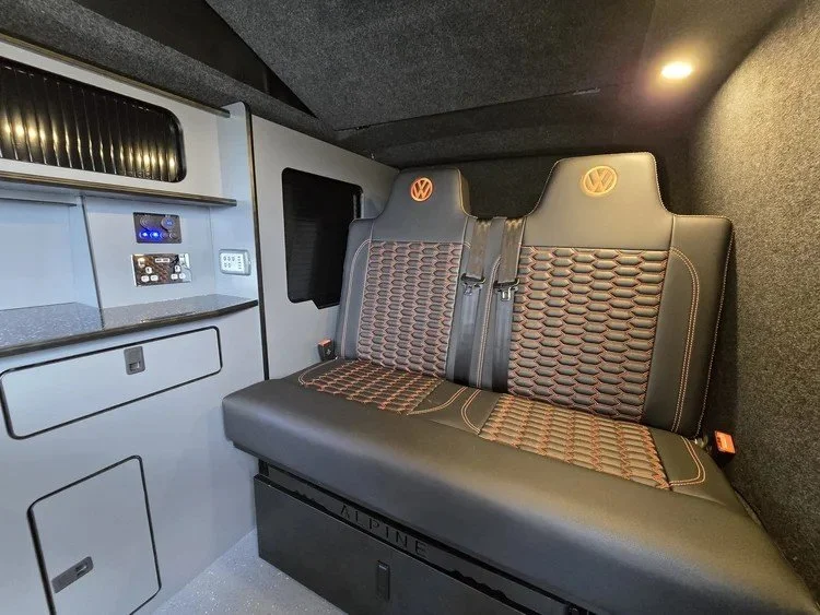 Professionally reupholstered campervan bench seat with matching wall and side panels.