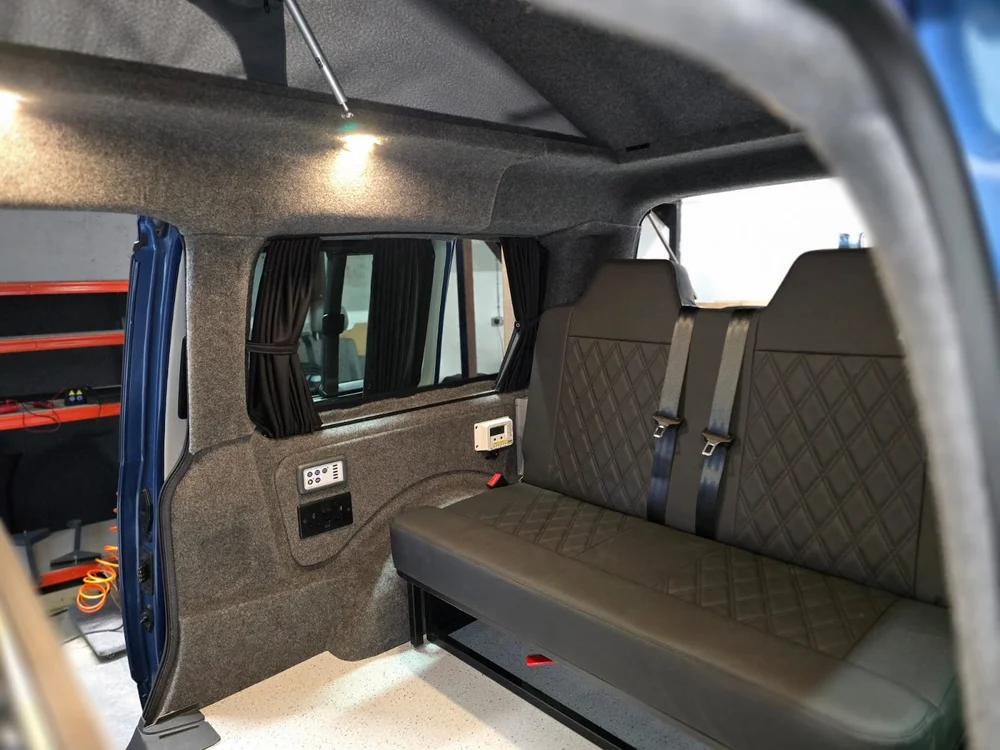 Rock and roll bed system in VW Caddy camper conversion