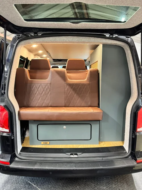 Rock and roll bed in upright seat position inside bespoke VW T6.1 campervan
