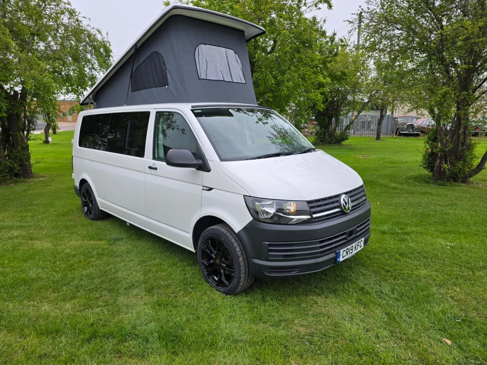 VW custom van exterior showing Vinnie, a VW T6.1 camper conversion with pop-top roof and black alloy wheels