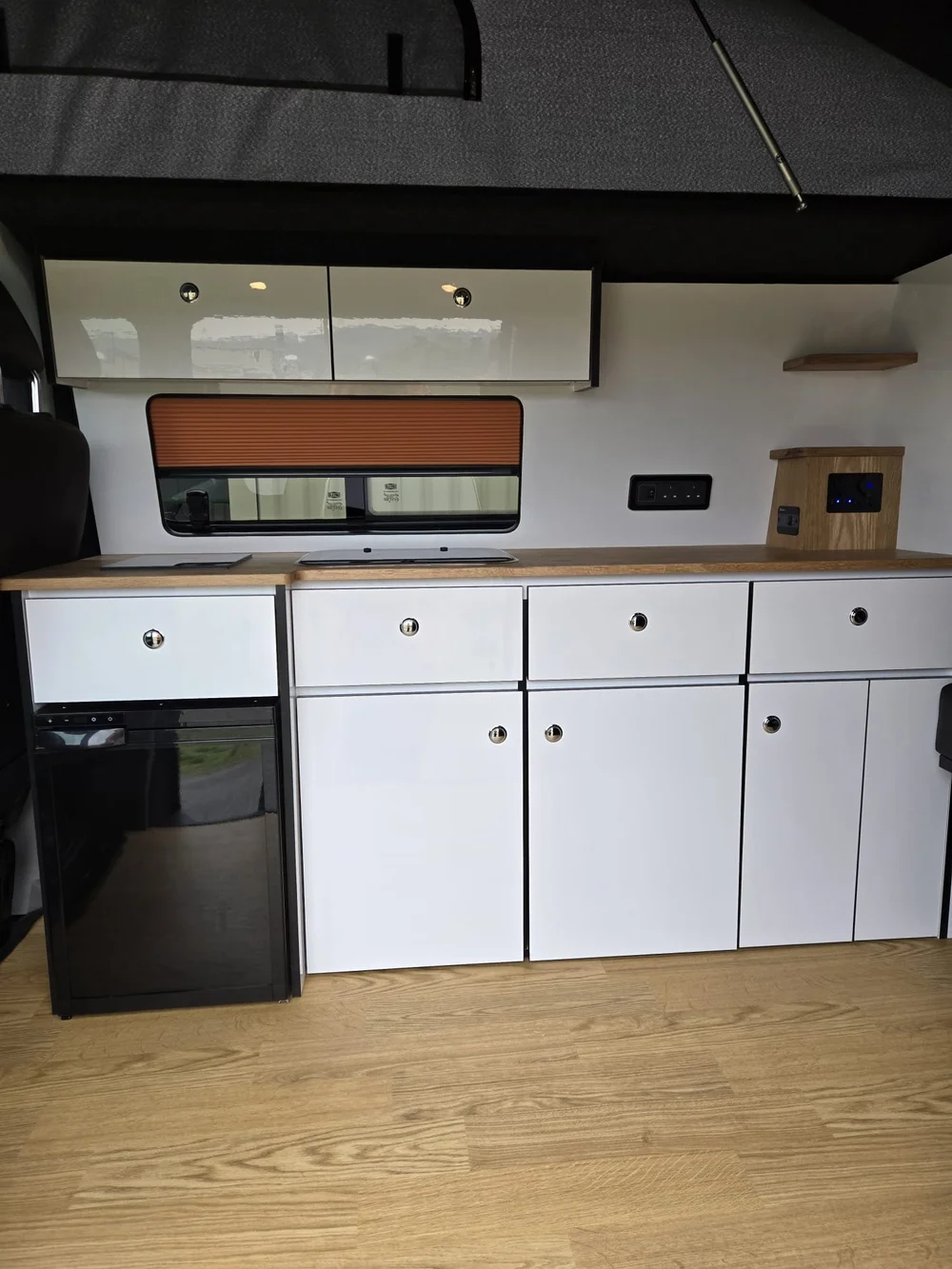 Custom storage solutions inside a VW T6.1 camper conversion designed for family travel and everyday use