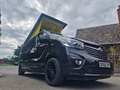 Custom Vivaro camper with yellow pop-top roof raised