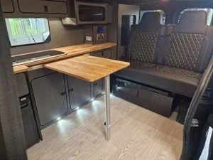 Bespoke Vivaro camper interior with oak table and seating