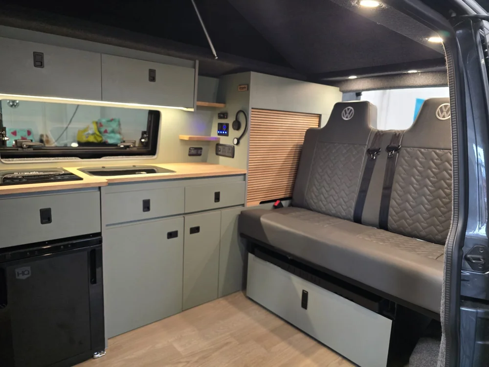 Custom van conversion interior with sage green cabinets in VW T6.1 camper Vera