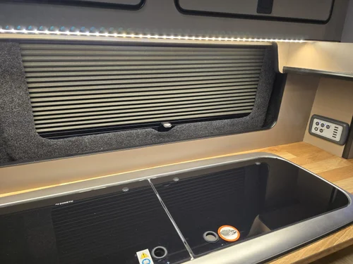 Kitchen worktop and cabinetry inside the bespoke Fiat Talento camper van conversion