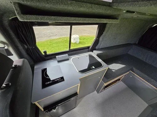 Induction hob and kitchen area in bespoke VW campervan
