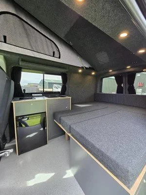 Sink and fridge unit inside bespoke campervan conversion