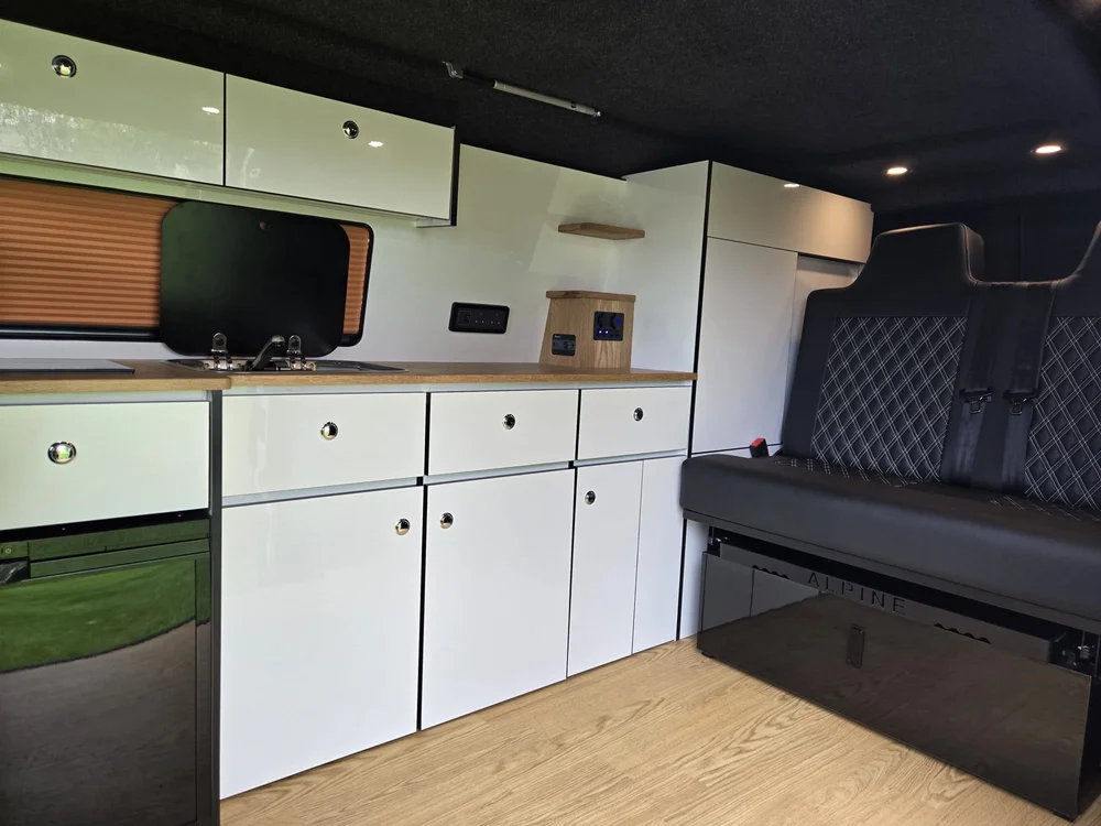 Induction hob and gas-free cooking setup in a VW T6.1 camper conversion kitchen