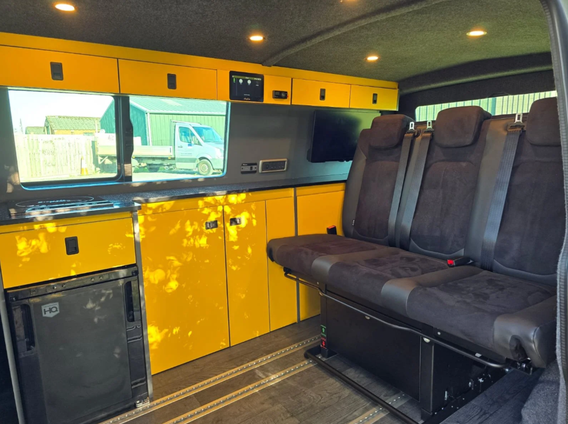Custom kitchen cabinets with bold colour finish inside a VW T6.1 camper conversion