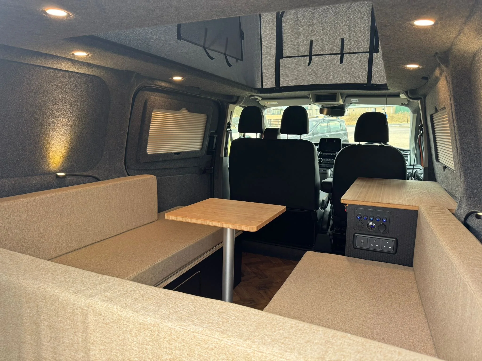 Custom U-shaped campervan seating with dining table