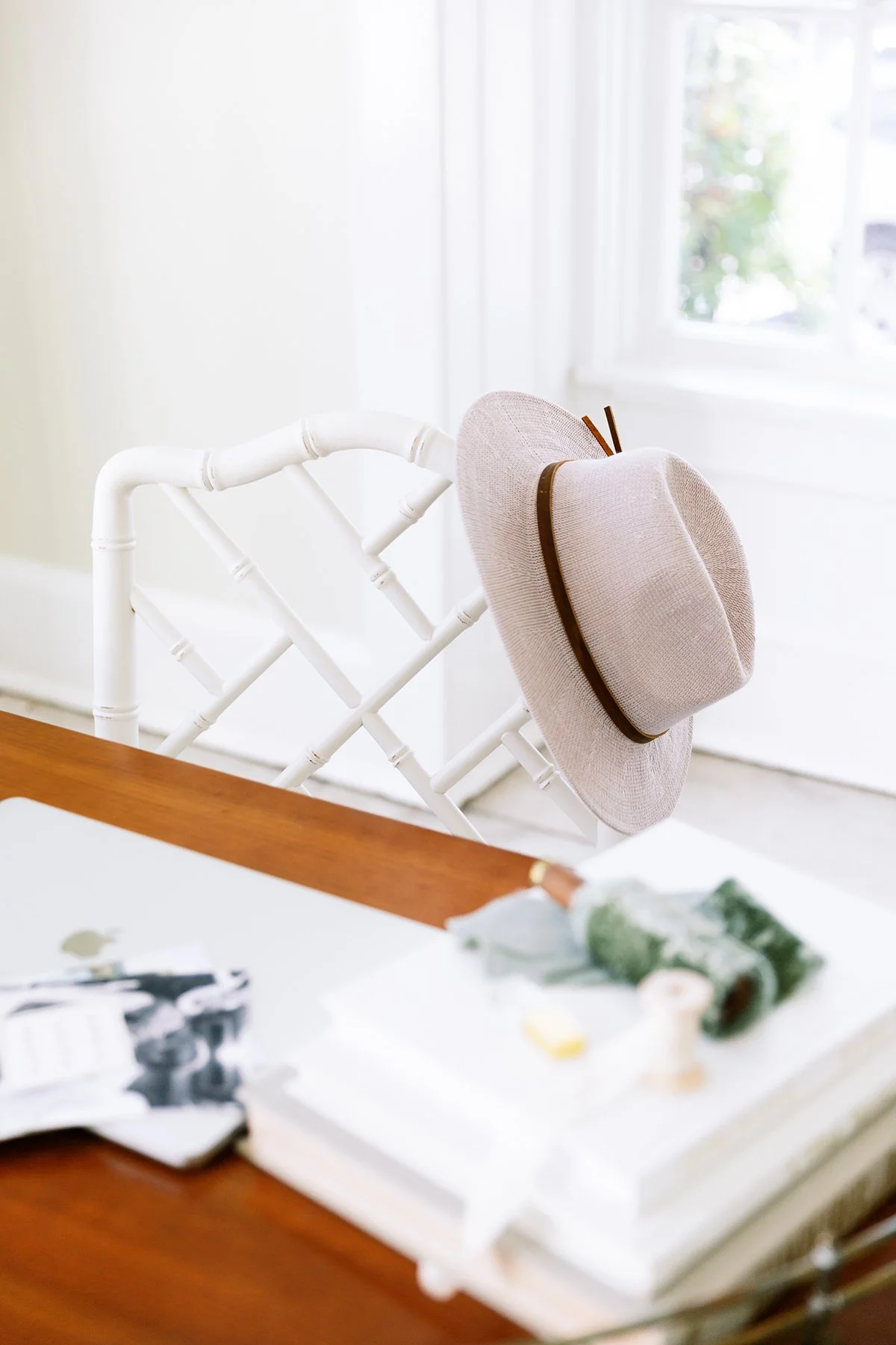 Minimal workspace with a chair and sunhat, representing the calm after launching your brand.