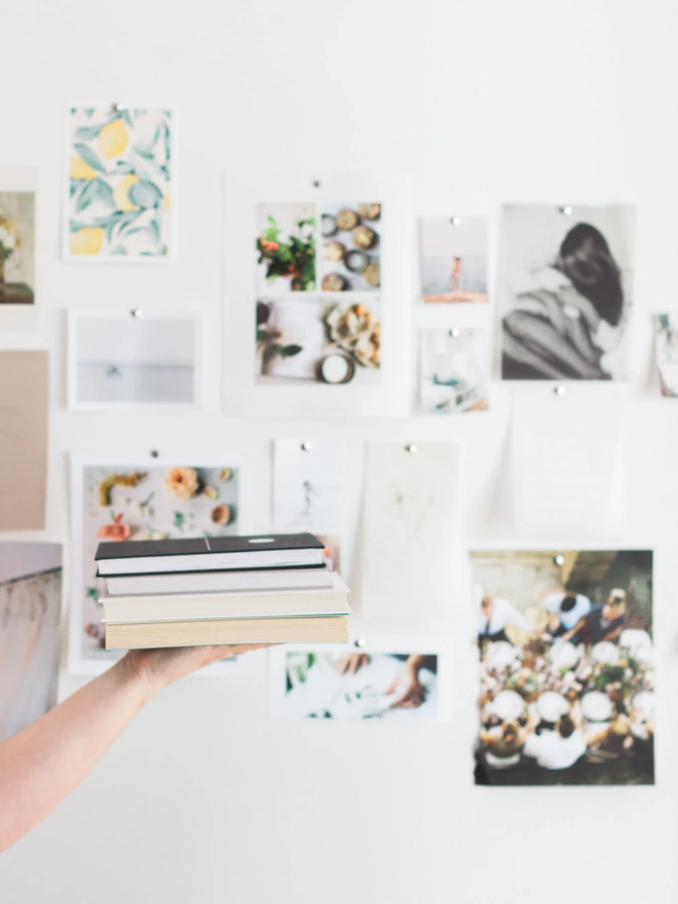 Soft-focus workspace photo with branding materials and a solo entrepreneur working at a desk.