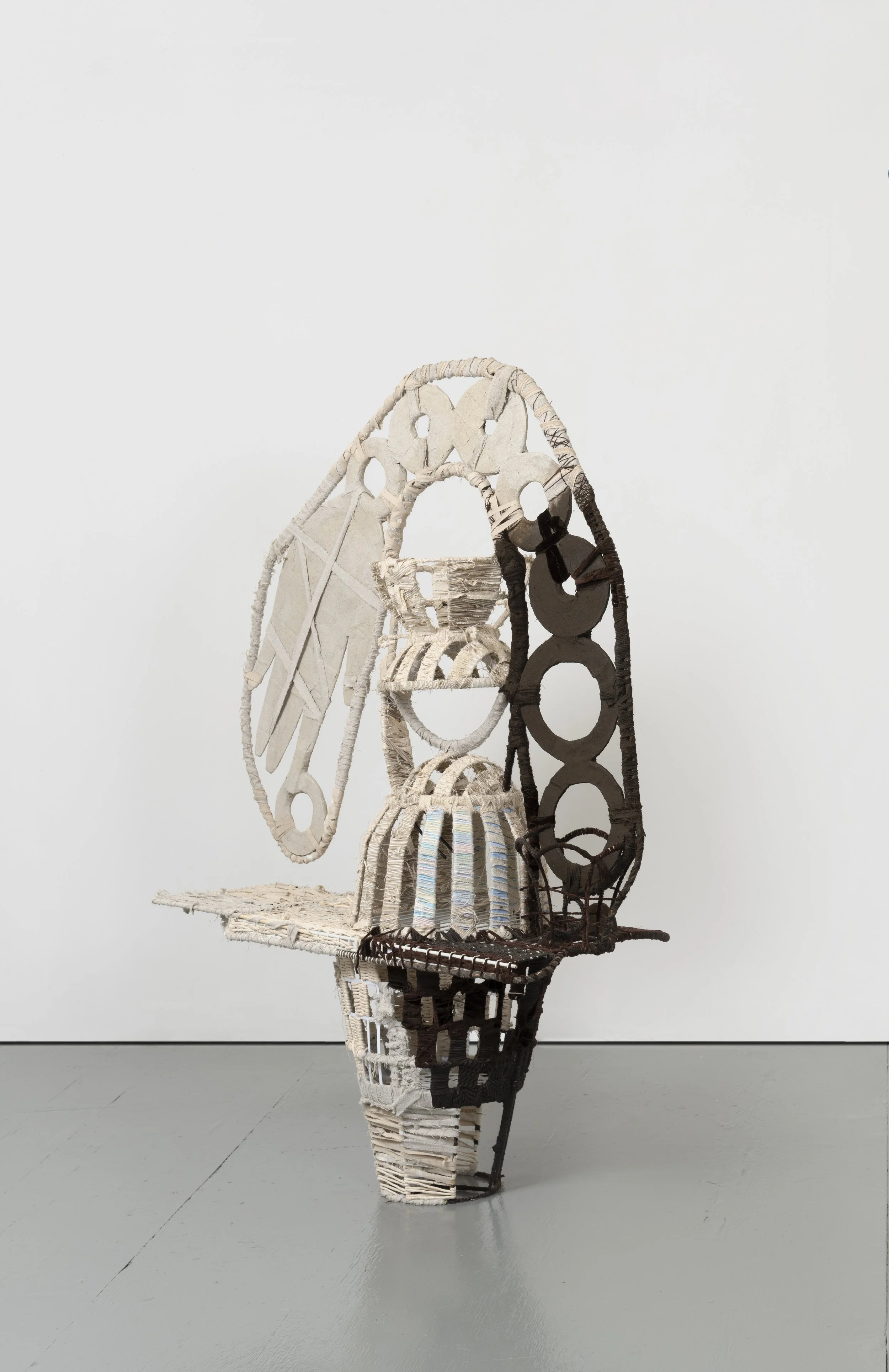  The Bean Counter,  2025 
Found objects, repurposed textiles, earth and mineral pigment 
59 x 60 x 16.5 inches
 
Image by Pierre Le Hors
