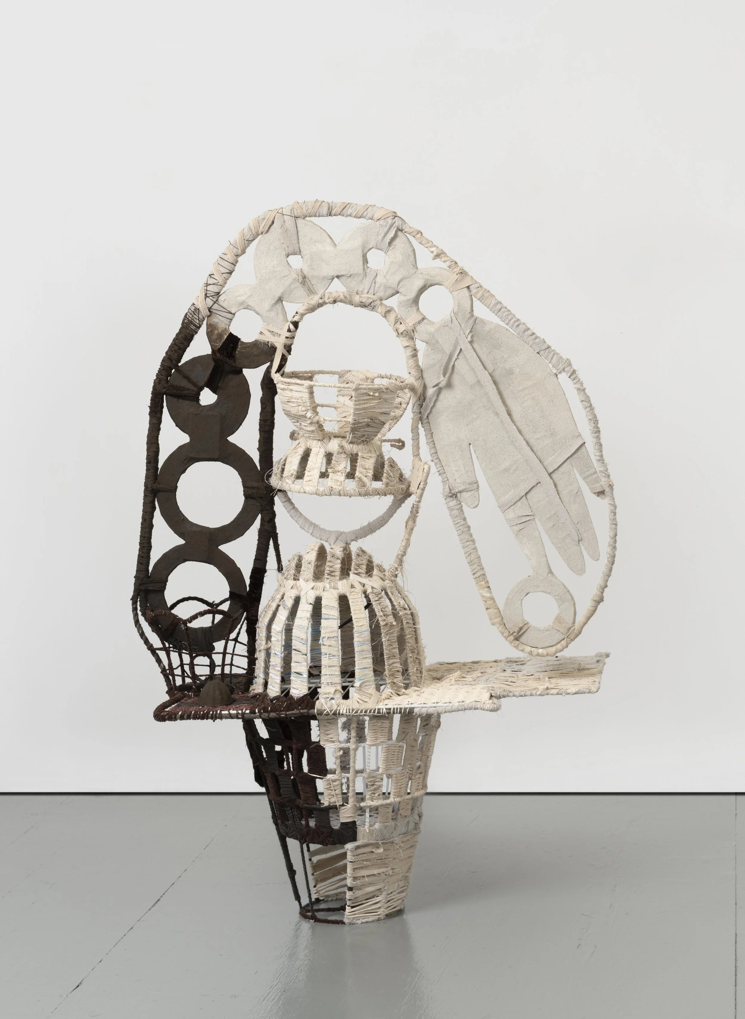  The Bean Counter,  2025 
Found objects, repurposed textiles, earth and mineral pigment 
59 x 60 x 16.5 inches
 
Image by Pierre Le Hors