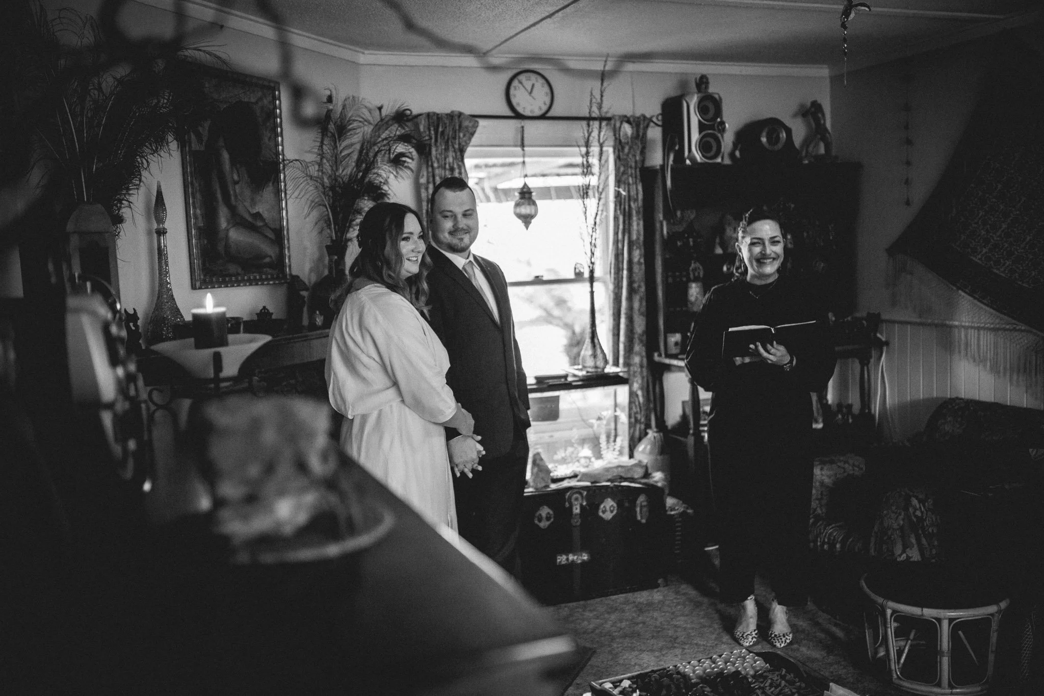 couple getting married in their living room in front of a fire