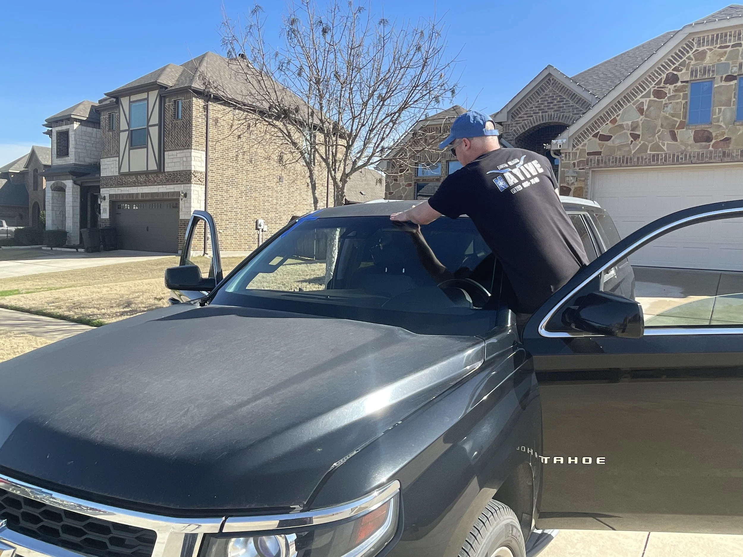 Auto Glass Native replacing a windshield of black chevrolet tahoe parked in Midlothian, TX neighborhood