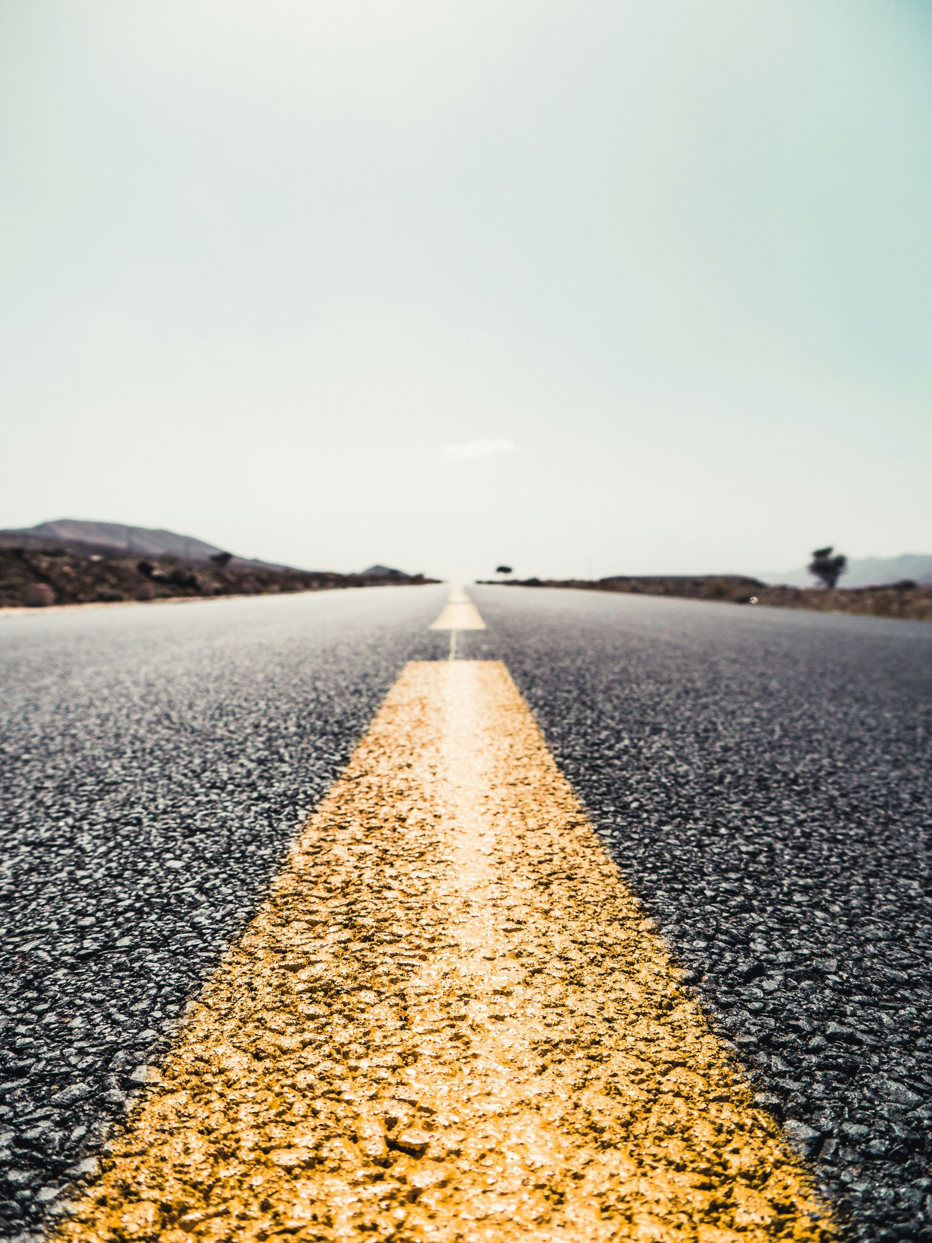 Close up of the yellow dotted line in the middle of a road