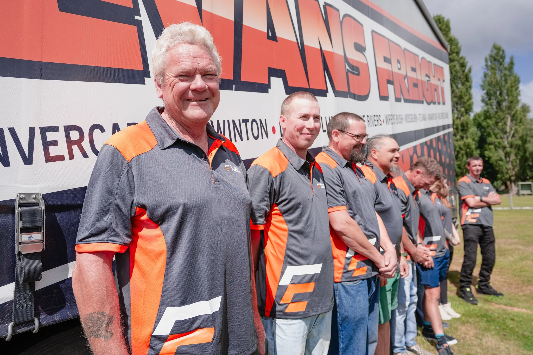 The Evans Freight team standing in front of their freight truck in Te Anau, Southland, New Zealand — a friendly local freight company serving Invercargill, Winton, Lumsden, Five Rivers, Wreys Bush, Mossburn, Te Anau, Manapouri, and Milford Sound.