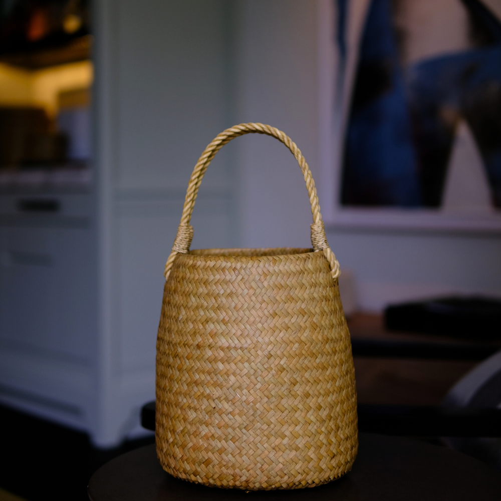 Close-up of basket on a dark wooden surface, softly lit interior.