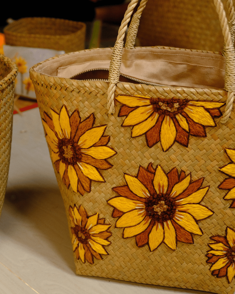 Close-up of Phatsajira Sunflower tote showing detailed Merino wool sunflower stitching and natural linen-lined interior crafted by artisans in Thailand.