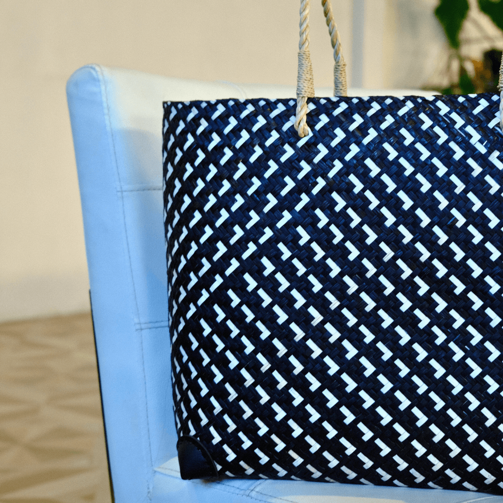 Side view of Na Yenn artisan tote highlighting bold black-and-white weave and structured silhouette – handmade from sustainable Krajood