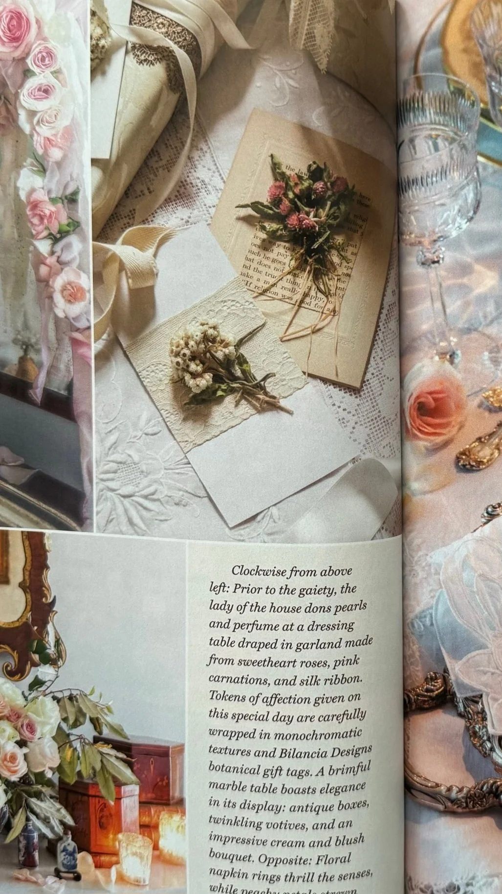 A vintage table setting with flowers, a piece of paper with a floral illustration, and a booklet with text about a decorative display.