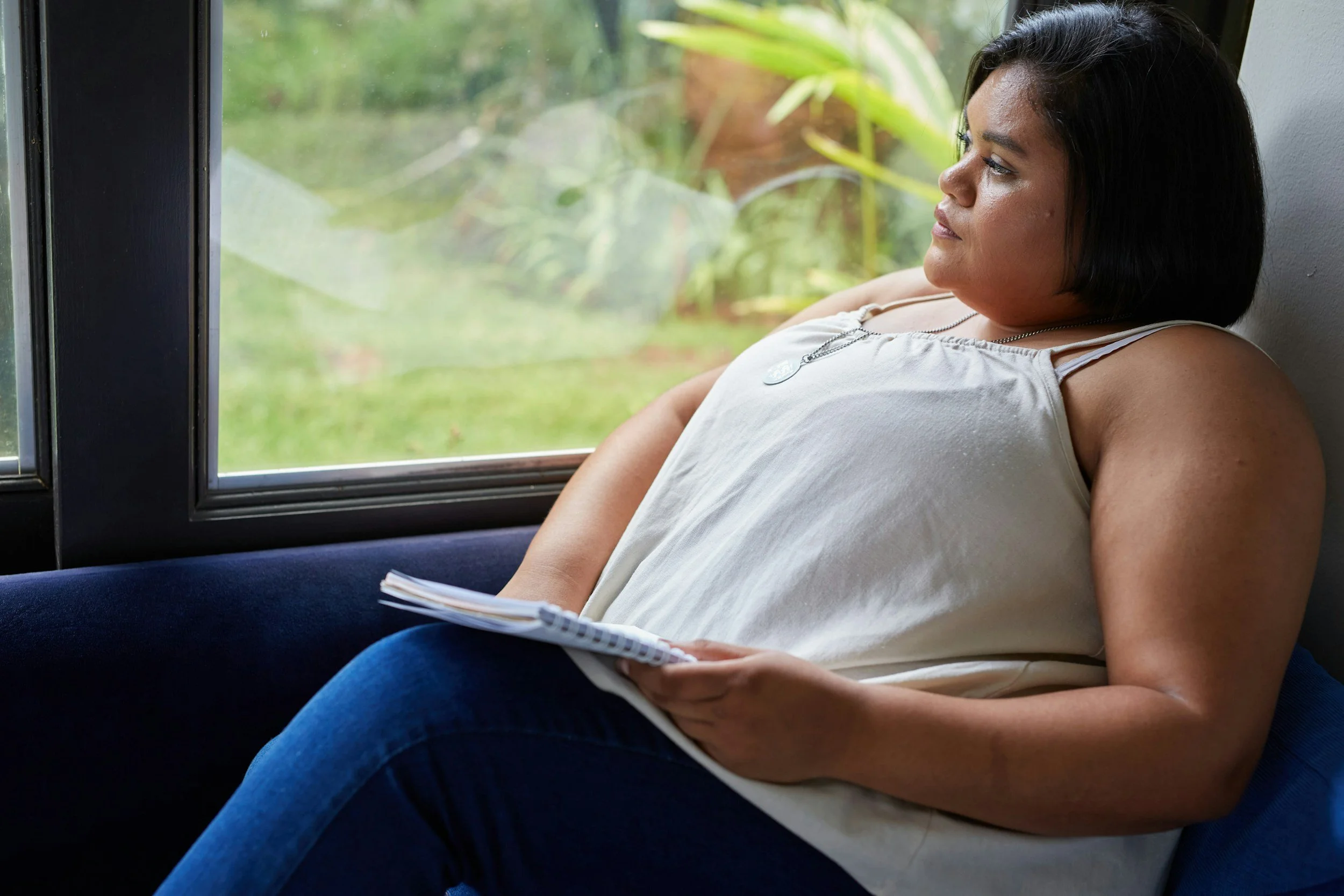 Woman experiencing PCOS symptoms including weight gain and fatigue