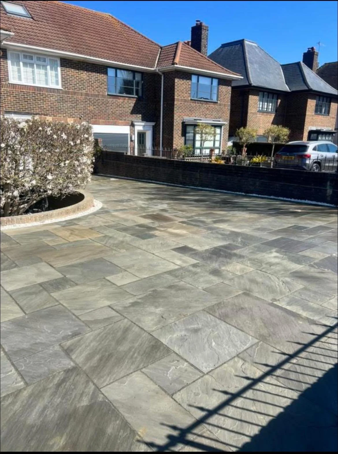 A residential driveway with stone paving constructed by JD Driveways. 