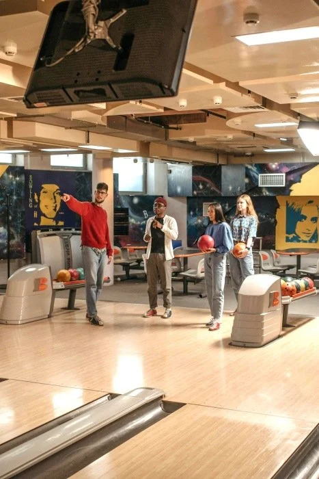A group of teens at a bowling alley.