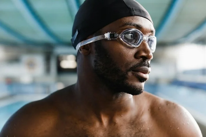 Close up of a swimmers face looking to the side.