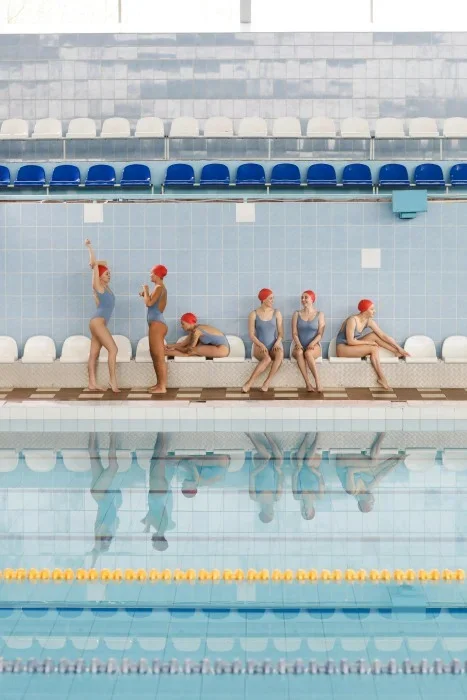 A swim team at an indoor pool.