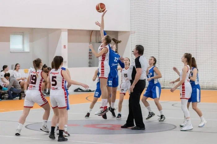 A women's basketball game at the ball tip.
