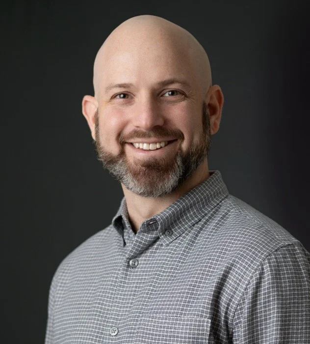 A headshot of Brad Bryk, smiling.